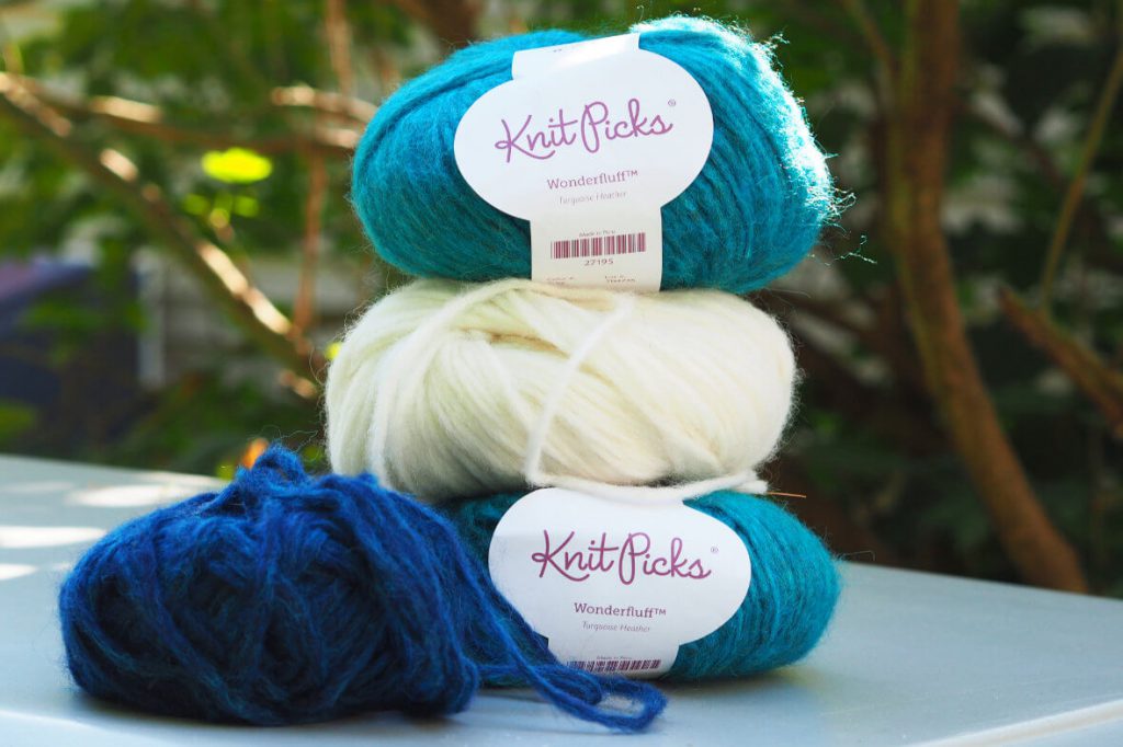 four balls of Knit Picks Wonderfluff yarn on table