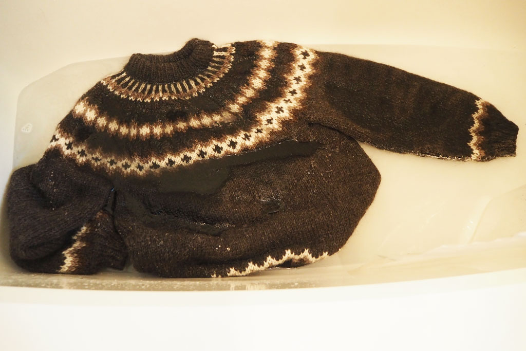 Brown Icelandic sweater in tub.